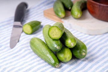 Tasty raw organic mini baby cucumbers, micro one bite cucumbers, for finger food and sandwiches, on...