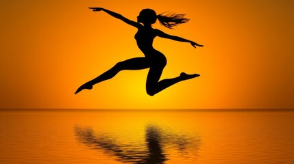 Silhouette of a woman leaping at sunset over water. Possible use Stock photo for inspirational or athletic concepts