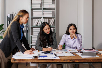 Stressed annoyed office employee manager having headache migraine at business meeting with colleagues about business problem they have to solve. Stress at work or migraine concept.
