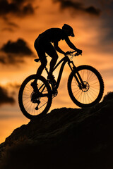 Obraz premium Golden Hour Sunset Cyclist Mountain Biking Coastal Cliff Descent Adventure Outdoors Sport