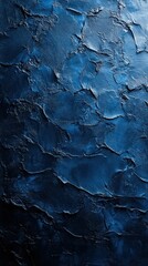 Obraz premium Deep blue textured surface showcasing layers and shadows in a dramatic light setting