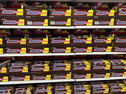 Lviv, Ukraine - February 16, 2025: Shelf Filled With Snickers Chocolate Bars in Grocery Store Display