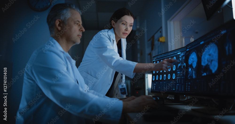 Aufkleber in control room doctor and radiologist discuss diagnosis while watching procedure and monitors showi