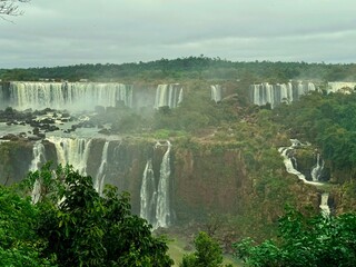 Iguazu Falls. Water falling on multiple levels surrounded by dense jungle. Natural panoramic view