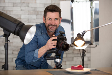 male photographer taking photos of food