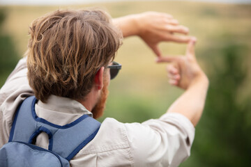 man making frame hand on nature landscape