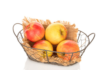 Several apples in a basket, close-up, isolated on a white background.