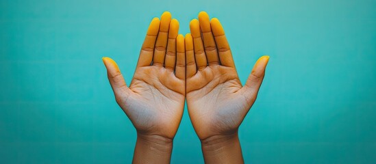 Vibrant Yellow Hands Against Teal Background