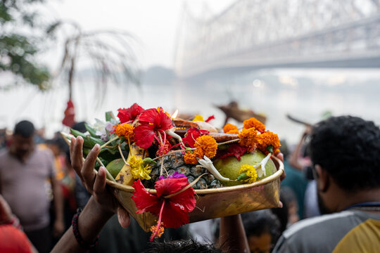 Devotee holding offerings during chhath puja celebration in kolkata