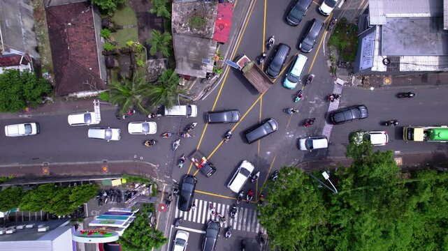 Crowd on the crossroad in Asia. Many cars and bikes try to pass crossroad. Traffic jam on busy intersection