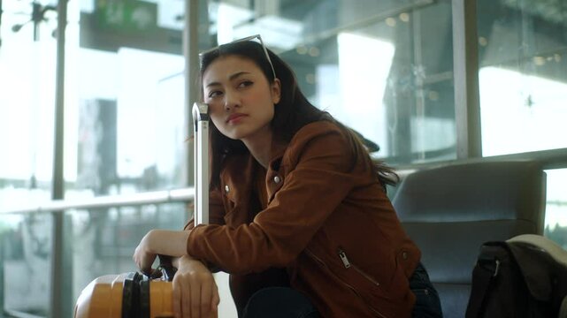 Unhappy young woman traveler disappointed with flight delay or cancelation while waiting at airport terminal, female tourist upset after receiving bad news when sitting at airline lounge.
