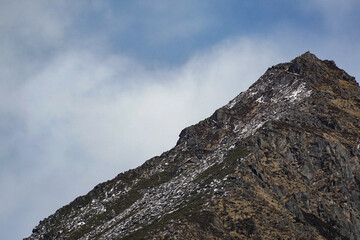 Majestic mountain peak rocky terrain nature photography cloudy sky close-up view adventure inspiration