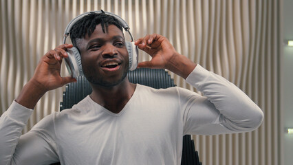 African American ethnic cyber man in white futurism studio indoors singing happy party male guy...