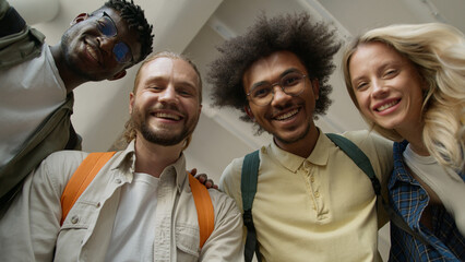 Bottom view university college four students happy excited winners amazed say wow multiracial...