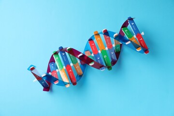 Colorful DNA structure model on light blue background, top view