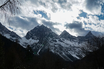Fototapeta premium Majestic snow-capped mountains alpine region nature photography cloudy sky wide angle natural beauty