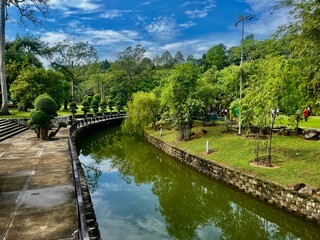 Fototapeta premium A tranquil river flowing through a picturesque lake, surrounded by lush greenery, scenic landscapes, and natural beauty.