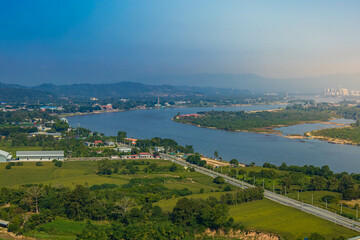 An aerial view of the road running parallel to the river and the skyline of Chiang Khong