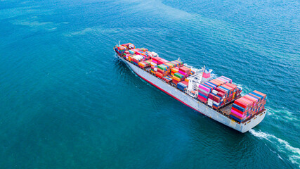 A large number of container ships are sailing at sea.