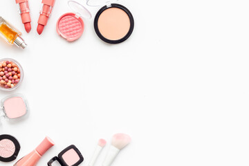 Layout of makeup cosmetic and brown pink shade beauty products, top view