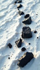 Dark resin fragments on pristine white surface, ancient earth, rugged surfaces