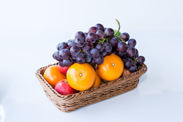 Assorted fresh mix fruits in a rectangle basket on white background, concept fruit in shop and supermarket..
