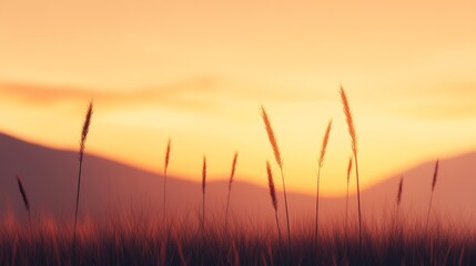 Silhouetted grass swaying gently in the warm glow of a sunset over distant mountains