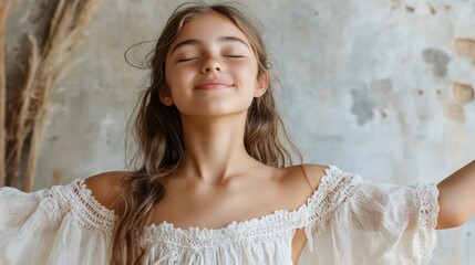 Fototapeta premium A girl in a delicate dress, closing her eyes with joy, empty space for text. 