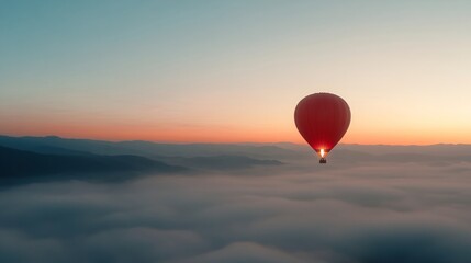 Fototapeta premium Red hot air balloon floating above misty clouds at sunrise. Adventure travel panoramic view with orange and blue sky over foggy mountain landscape. Scenic aerial journey