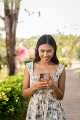 young woman using phone outdoors