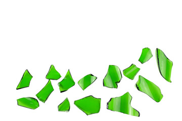 Sharp and jagged pieces of broken green glass cut out on a white background, symbolizing fragility and caution.