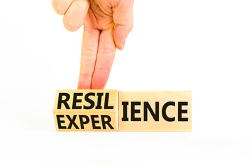 Resilience or experience symbol. Concept words Resilience Experience on beautiful wooden blocks. Beautiful white background. Businessman hand. Business resilience or experience concept. Copy space