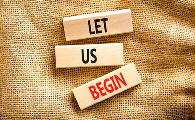 Let us begin symbol. Concept words Let us begin on beautiful wooden blocks. Beautiful canvas table...