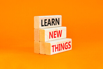 Learn new things symbol. Concept words Learn new things on beautiful wooden blocks. Beautiful orange table orange background. Business motivational learn new things concept. Copy space.