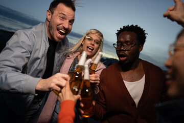 Group of Multi-Ethnicity people having fun outdoor in the night. Celebrate.
