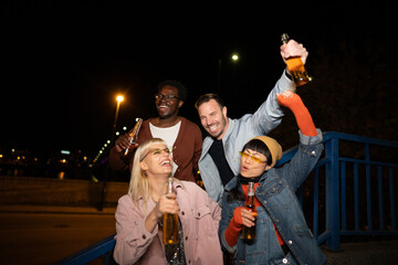 Group of Multi-Ethnicity people having fun outdoor in the night. Celebrate.
