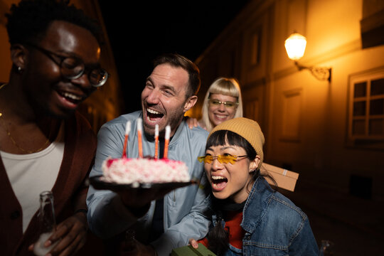 Group of Multi-Ethnicity people having fun outdoor in the night. Celebrate.