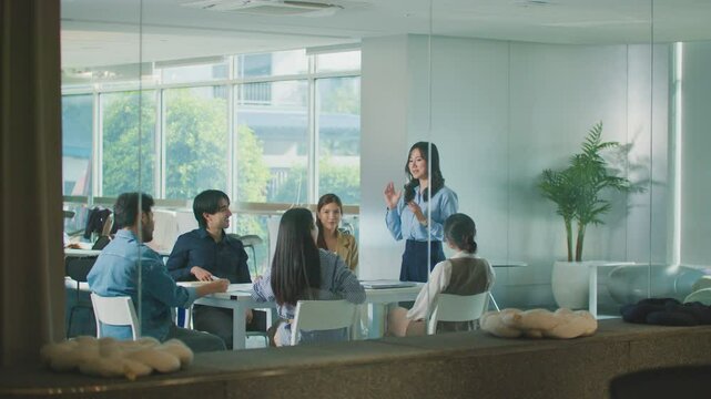 Confident Women leader discussing strategy meeting teamwork collaboration business growth analysis financial data presenting reports managing startup success corporate office people partnership