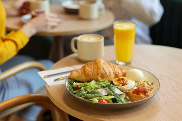 Women having tasty breakfast in cafe, selective focus