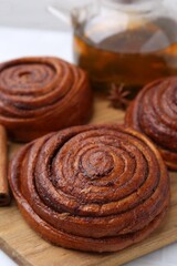 Delicious cinnamon rolls on white table, closeup