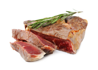 Pieces of delicious beef meat and rosemary isolated on white