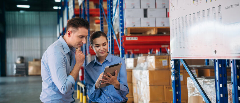 Warehouse worker working and checking the stock in the warehouse. .Factory manager using digital tablet check barcode in industry factory logistic.