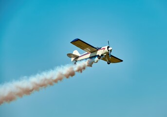 Vintage airplane performing aerial stunt in sky