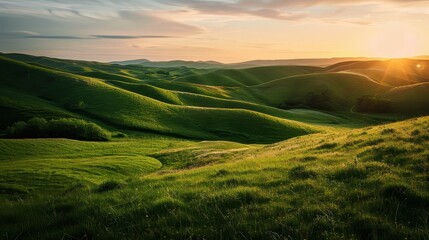 Obraz premium Beautiful sunset casting warm light over lush green hills