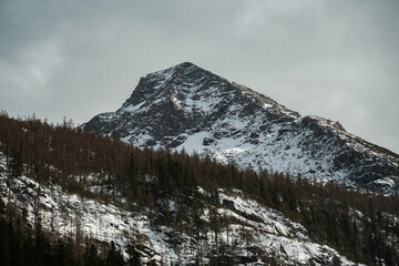 Snow-capped mountain peak alpine region landscape photography serene environment majestic viewpoint nature's splendor