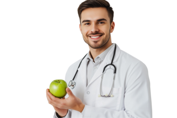 a male dentist in a white coat holds a green apple against isolated on a transparent background