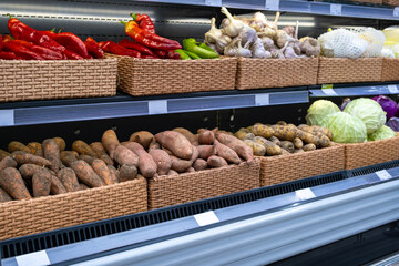 Boxes of vegetables in a supermarket, sale of carrots and other vegetables, Selective Focus Store.