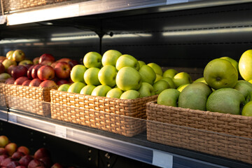 Baskets of apples in a store, selection of ripe apples.