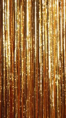 Glimmering gold tinsel curtain backdrop for festive celebrations and elegant event decoration creating a luxurious and radiant atmosphere with vertical lines