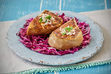 wasabi seared ahi tuna served on a red cabbage coleslaw